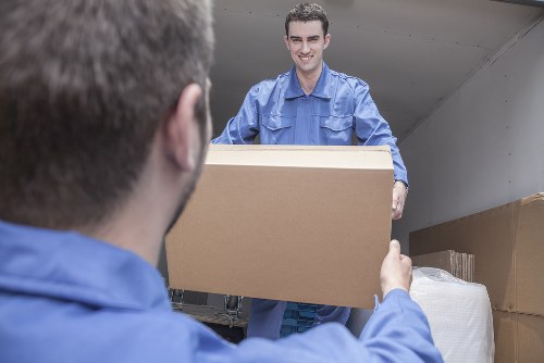 Home moving team loading boxes in a Tottenham residential street